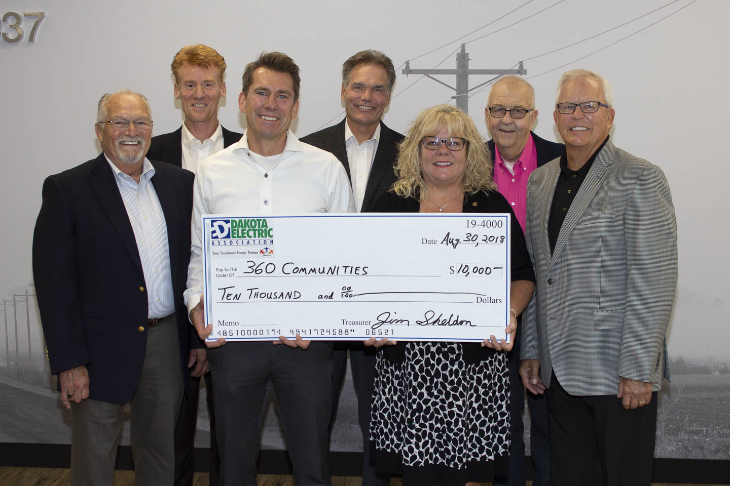 group holding large check