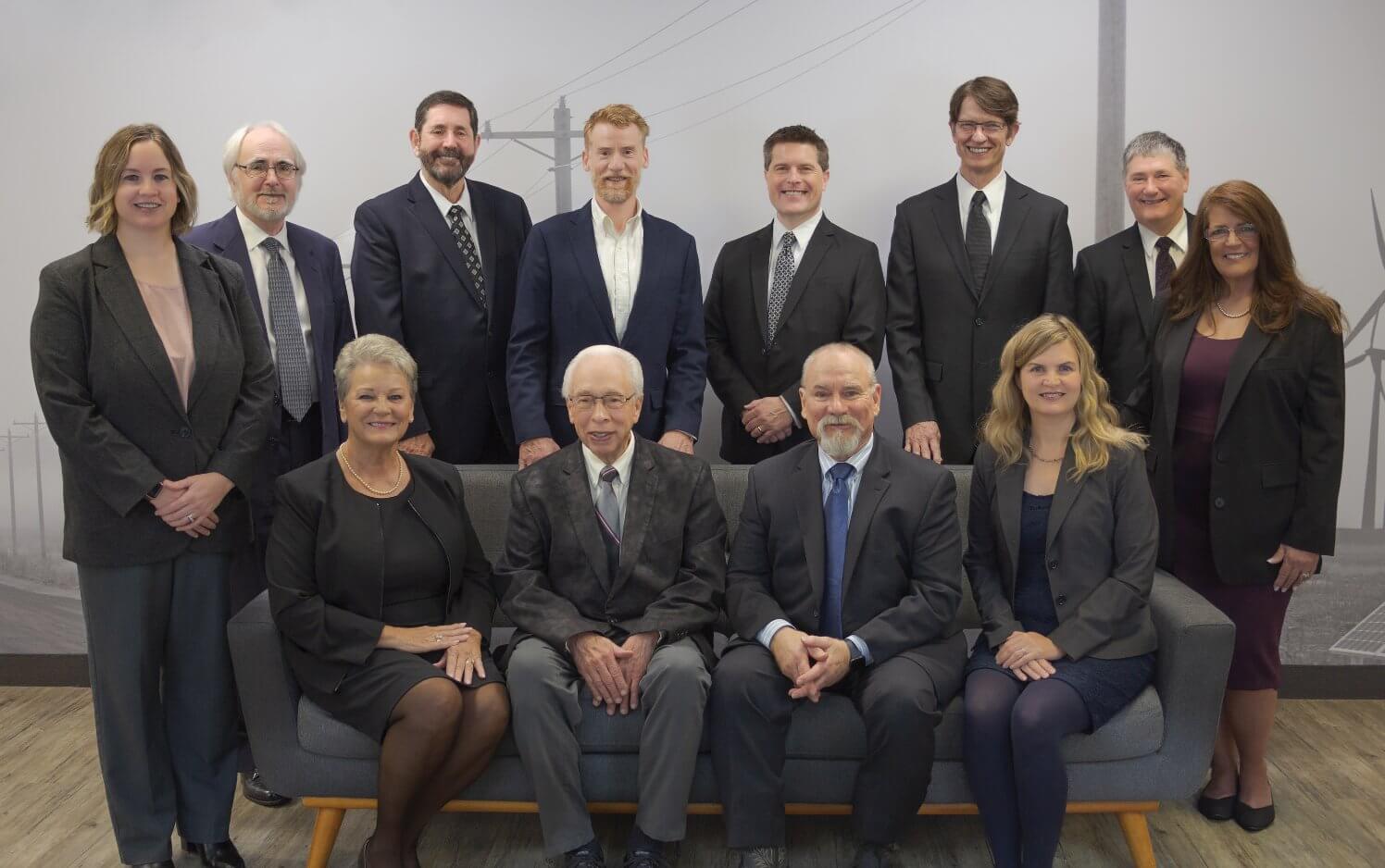 a group of men and women wearing suits