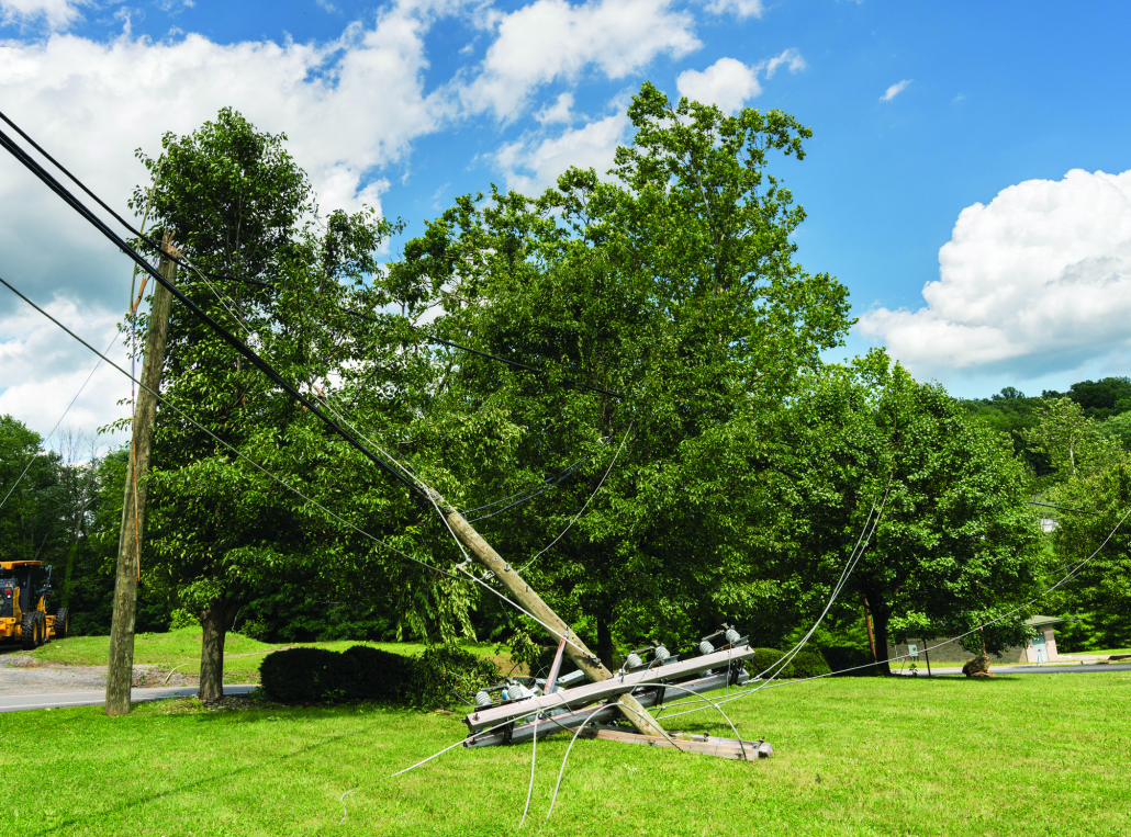 Snapped and downed power post and line after storm