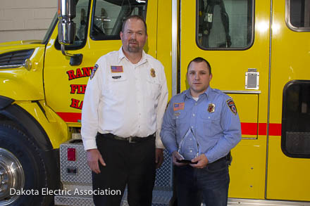 Jake holding the award with Chief Whitson.