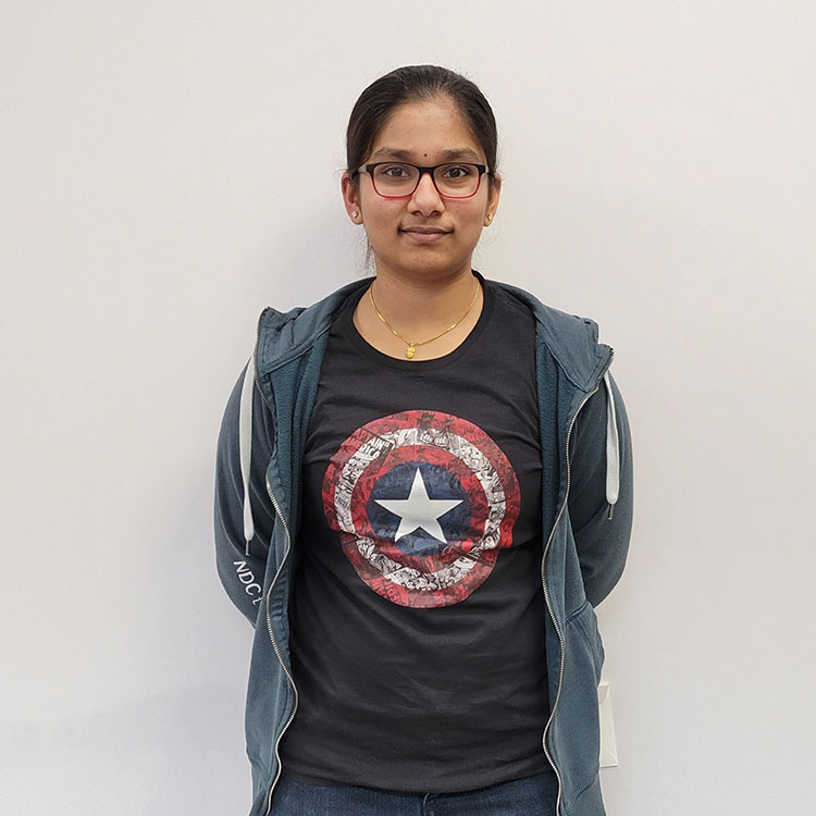 high school student with glasses and captain america shirt smiling